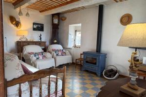 a room with a bed and a blue stove at Le Clos Lau-Tave Charming 110 m Provençal home with private garden in Simiane-la-Rotonde
