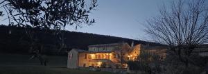 a large house with its lights on at night at Le Clos Lau-Tave Charming 110 m Provençal home with private garden in Simiane-la-Rotonde