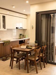 a kitchen with a wooden dining room table and chairs at VEC Homes - Triển lãm VEC Đông Anh - Căn hộ 2 phòng ngủ in Dong Anh