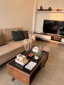 a living room with a couch and a coffee table at VEC Homes - Triển lãm VEC Đông Anh - Căn hộ 2 phòng ngủ in Dong Anh