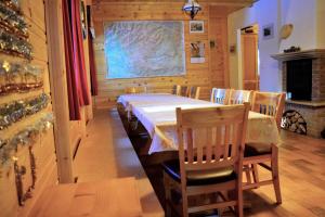 a dining room with a table and chairs and a fireplace at Chalet Pokljuka in Goreljek