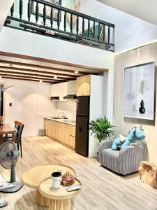 a kitchen and living room with a staircase in a house at Hyn's House in Danang