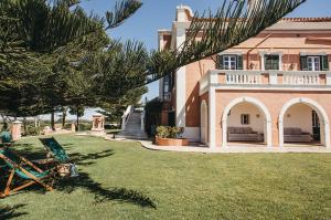 a house with a green lawn in front of it at Agroturismo Son Triay in Ferreries