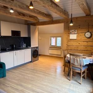 a kitchen and dining room with a table in a room at Nõmme Apartments in Tallinn