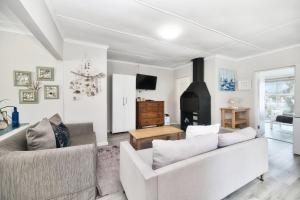 a living room with two couches and a fireplace at 32 Main Road in Struisbaai