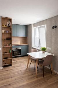 a kitchen with a table and chairs in a room at Balvi Ezera Street in Balvi