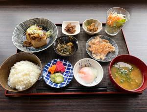 a tray of food with rice and bowls of food at Green Rich Hotel Kagoshima Tenmonkan in Kagoshima
