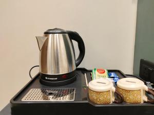a coffee pot sitting on top of a counter at Hotel Raas Vrindavan in Laling +27 photos