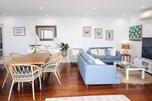 a living room with a blue couch and a table at St Helens in Edithburgh