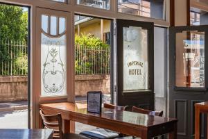 a table and chairs in front of a restaurant at Imperial Hotel Paddington in Sydney