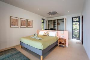 a bedroom with a bed in a room at Titine Villa in Srithanu +32 photos