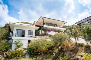 a house on a hill with flowers at Titine Villa in Srithanu