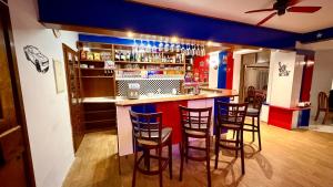 a bar in a room with stools around it at Motel Dareon in Náchod