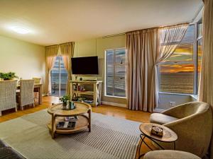 a living room with a couch and a tv at 75 Cap D'Azur in Strand