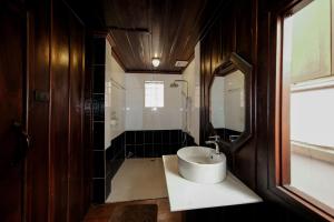 a bathroom with a sink and a mirror at Bualuang Hotel in Luang Prabang