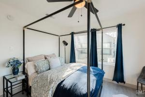 a bedroom with a canopy bed and a window at Luxury Stay Near Downtown Bakersfield in Bakersfield