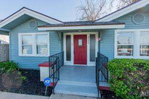 a blue house with a red door at Luxury Stay Near Downtown Bakersfield in Bakersfield