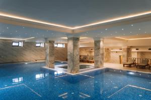 a swimming pool in the middle of a building at Medina Palace Hotel in Türkistan
