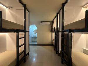 a room with bunk beds and a toilet in the background at Wangta in Haad Rin