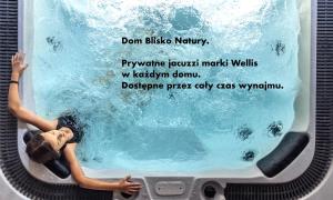 a woman swimming in a pool on a cake at Dom Blisko Natury Brenno in Brenno