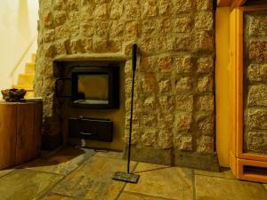 a brick wall with a television in a room at Sauna Paistaa in Sobetsu