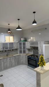 a kitchen with wooden cabinets and a stove top oven at اطلال الهدا Al-Hada ruins in Taif