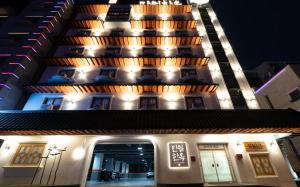 a building with lights on the side of it at Manwol Hotel Yuseong in Daejeon