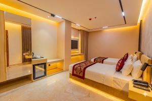 a hotel room with a bed and a television at Monsoon Courtyard Luxury Hotel in Dhaka