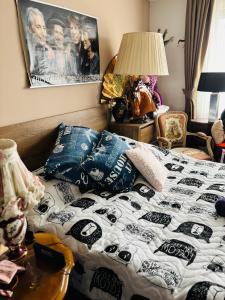 a bedroom with a bed with a black and white comforter at Experience at Malinova dolina in Sofia