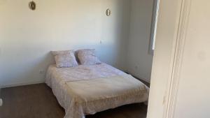 a bedroom with a bed with two pillows on it at Champvert in Champvert