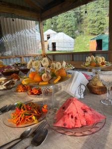 a table with many plates of food on it at "Ethno Yurt Camp Argymak" Altyn Arashan in Mineralʼnyy Istochnik Altyn-Arasan
