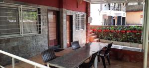 a patio with a table and chairs on a balcony at Leela villa - Ancient Redstone Escape in Panchgani +9 photos