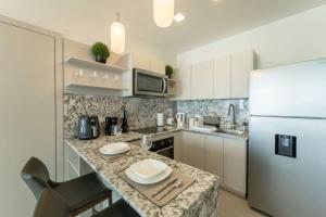 a kitchen with a counter top and a refrigerator at Deluxe Loft Apt with City View in Panama City
