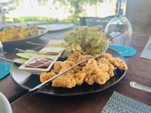 a plate of food with shrimp and vegetables on a table at Cote Resort in Dipaculao