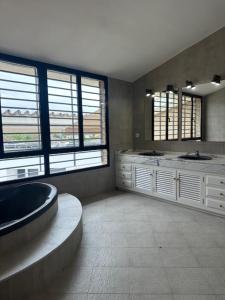 a large bathroom with two sinks and two windows at El Puente de Sansueña in Córdoba +42 photos