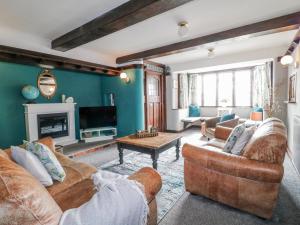 a living room with two couches and a tv at Fields Farm in Draycott in the Moors