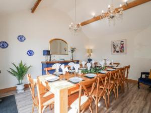 a dining room with a wooden table and chairs at Fields Farm in Draycott in the Moors