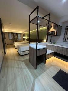 a large bedroom with a bed and a mirror at May Three Farm in Puerto Galera