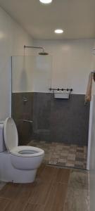 a bathroom with a toilet and a glass shower at Cote Resort in Dipaculao
