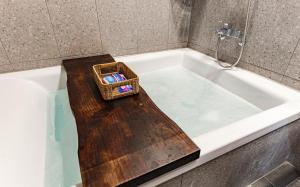 a wicker basket sitting on top of a bath tub at Manwol Hotel Yuseong in Daejeon +19 photos