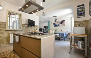 a kitchen with a sink and a stove top oven at Maison De Paris in San Giovanni la Punta