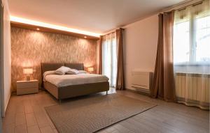 a bedroom with a bed and a large window at Maison De Paris in San Giovanni la Punta