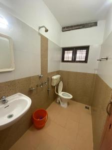 a bathroom with a sink and a toilet at Tech City Hotel Trivandrum in Trivandrum