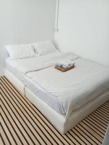 a white bed with a tray on top of it at BN Residence in Ko Tao
