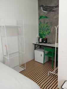 a bedroom with a bed and a desk and a table at BN Residence in Ko Tao