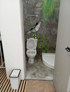 a bathroom with a toilet and a bath tub at BN Residence in Ko Tao