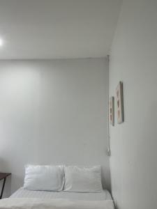 a white room with a bed with white sheets at BN Residence in Ko Tao +58 photos