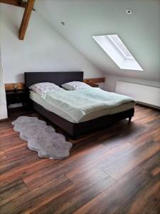 a bedroom with a bed and a rug on a wooden floor at Bullerbü in Fincken
