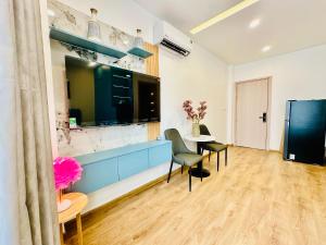 a living room with a blue cabinet and a table at Myla House in Ho Chi Minh City