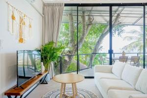 a living room with a white couch and a table at v27 Sunset Horizon Villa Seaview in Haad Yao